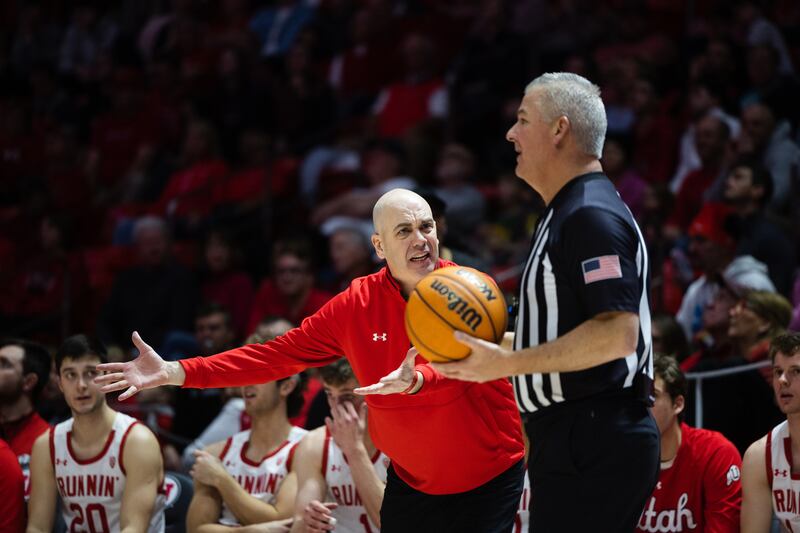 Utah head coach Craig Smith argues with the referee
