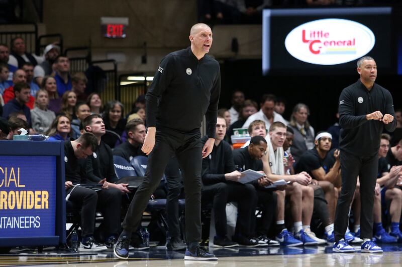 BYU coach Mark Pope, center, reacts during a game against West Virginia, Saturday, Feb. 3, 2024, in Morgantown, W.Va.