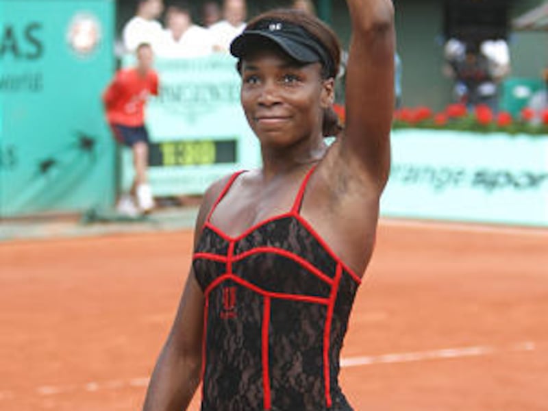 Venus Williams waves after defeating Dominika Cibulkova during their third round match for the French Open tennis tournament at the Roland Garros stadium Friday in Paris.