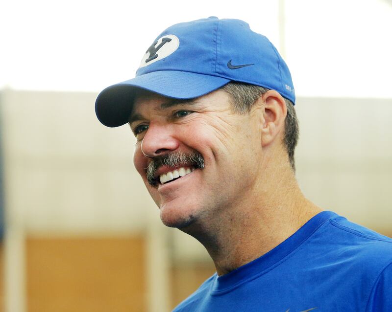 BYU's offensive coordinator Jeff Grimes talks with friends and media after a walkthrough in their indoor practice facility in Provo on Friday, Aug. 10, 2018.