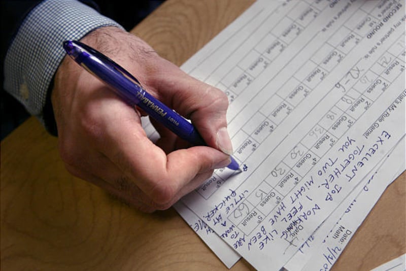 Sixth grade math teacher Justin Kazmark marks report cards with a purple pen at P.S. 188 in New York. He is among teachers who no longer use red pens when grading.