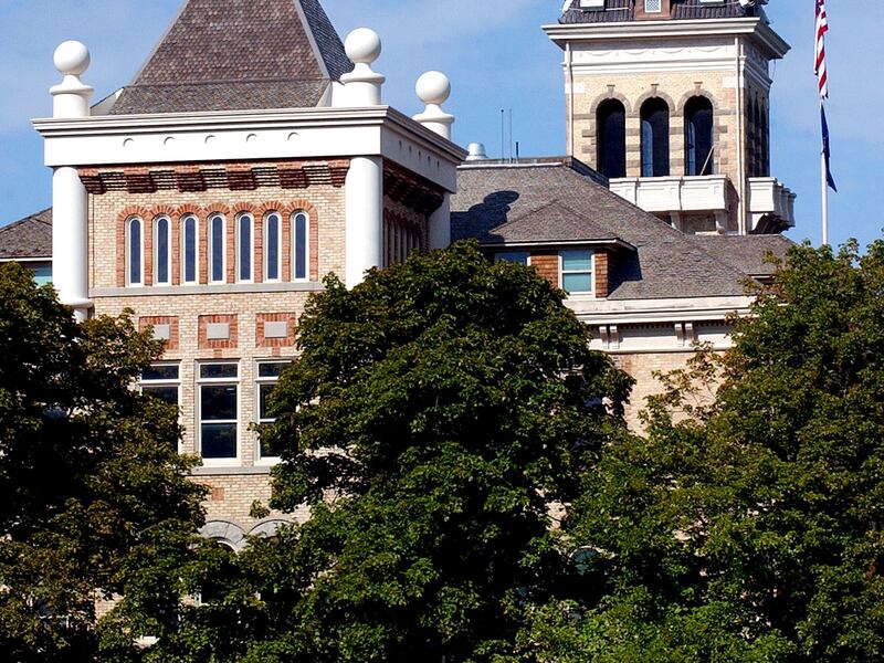A pedestrian passes Old Main on the campus of Utah State University, Friday, August 23, 2002. photo by Jeremy Harmon (Submission date: 08/23/2002)