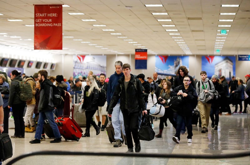 Travelers make their way through Salt Lake City International Airport on Monday, Jan. 8, 2018.