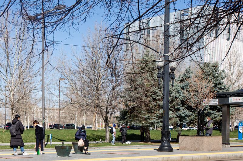 People practice social distancing at a TRAX station in downtown Salt Lake City on Friday, March 27, 2020.