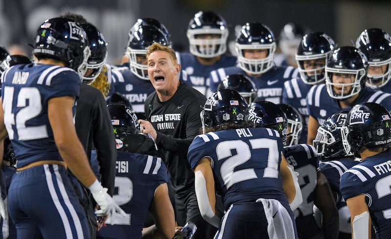 Utah State head coach Blake Anderson talks to players during a college football game against Colorado State on Oct. 7, 2023.