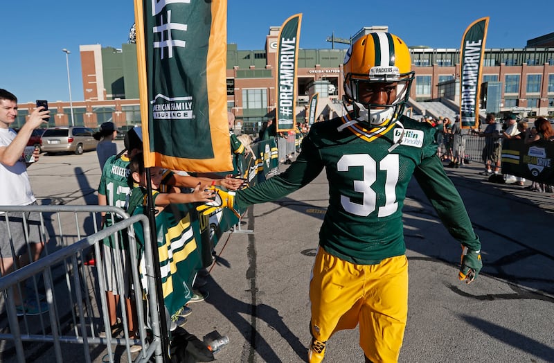 Green Bay Packers cornerback Robertson Daniel slaps hands with fans during NFL football training camp, Tuesday, July 26, 2016, in Green Bay, Wis.