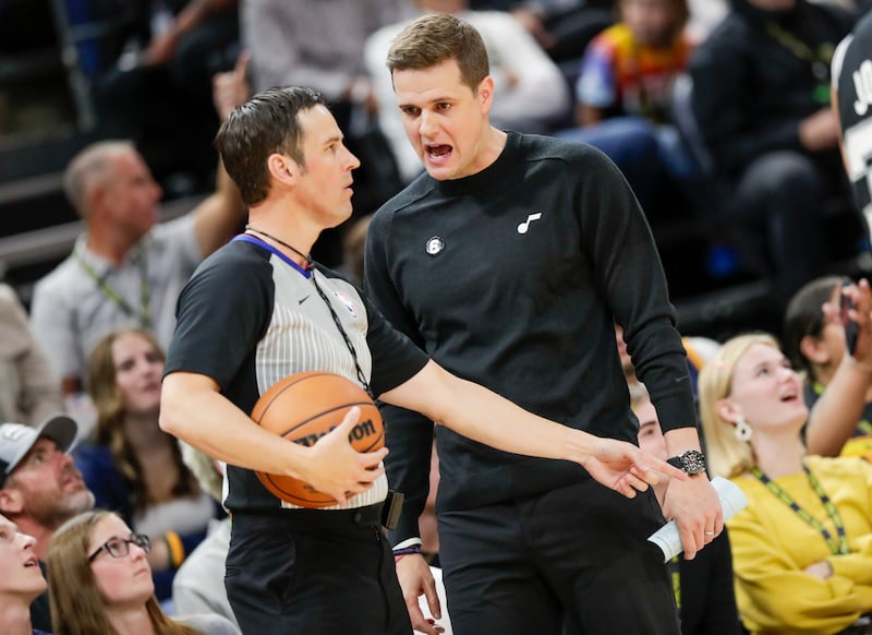 Utah Jazz coach Will Hardy talks to an official during a preseason game against San Antonio in Salt Lake City on Oct. 11, 2022.