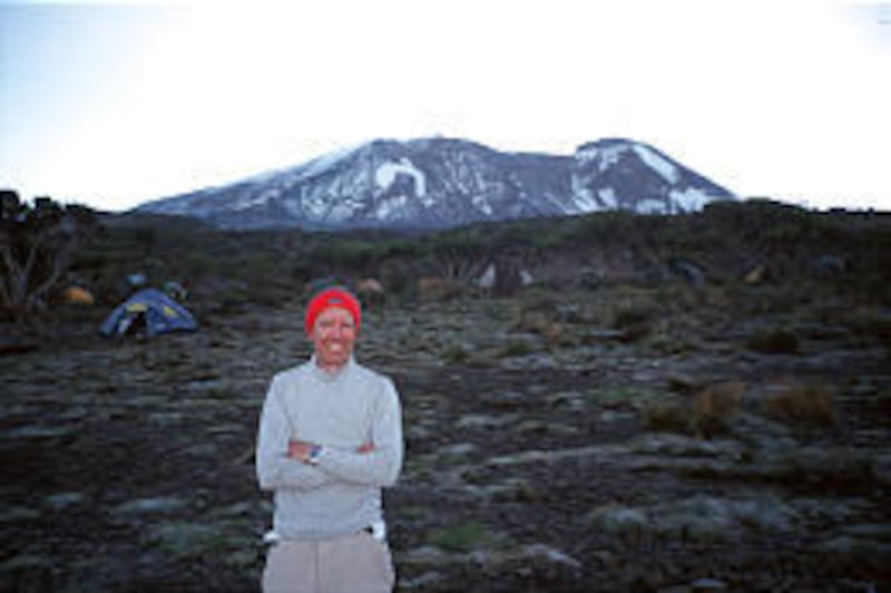 Michael Hannan, 59, stands on summit of Mount Kilimanjaro, which he climbed despite heart irregularities.
