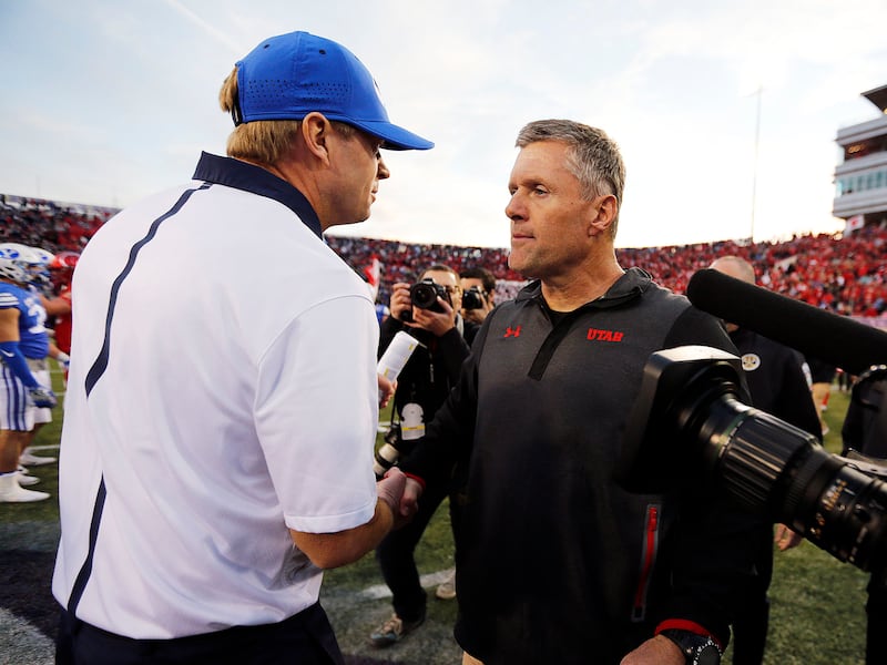 Brigham Young Cougars head coach Bronco Mendenhall, left, and Utah Utes head coach Kyle Whittingham meet following the Royal Purple Las Vegas Bowl.