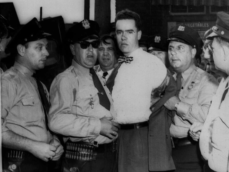 In this Sept. 6, 1949 picture, Howard Unruh, center, is shown with police after his capture in Camden, N.J. Unruh committed a mass murder the day before, gunning down 13 people, in an era when such killings were still rare. On Monday, Oct. 19, 2009, Camde
