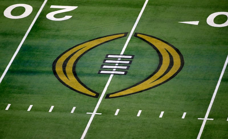 The College Football Playoff logo is shown on the field at AT&T Stadium. The College Football Playoff is set to remain a four-team format through the 2025 season