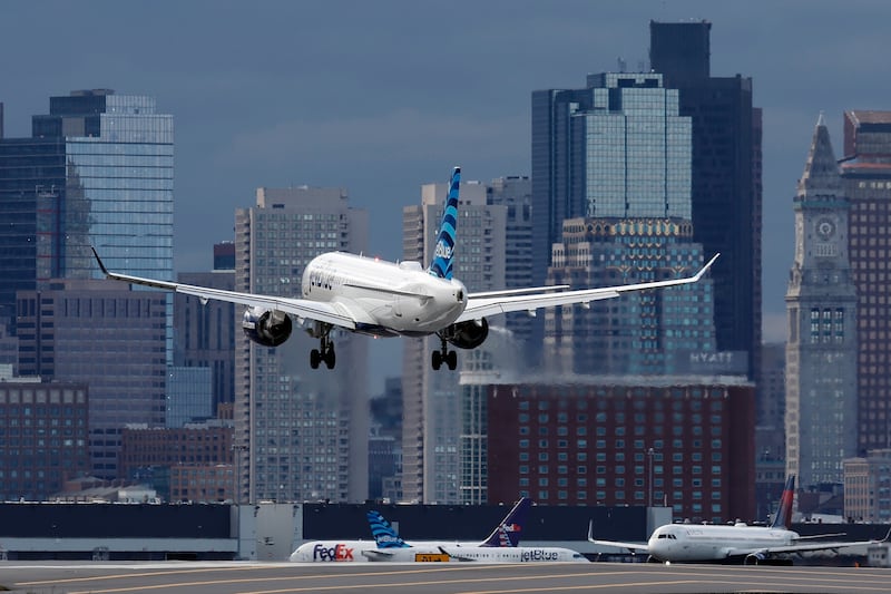 A JetBlue plane lands at Logan International Airport in Boston.
