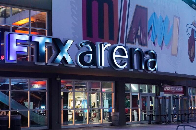 Signage for the FTX Arena, where the Miami Heat plays, is illuminated on Saturday, Nov. 12, 2022.