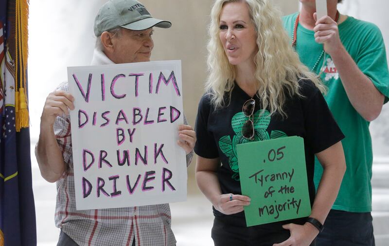 FILE - In this March 17, 2017, file photo, Ed Staley, left, and Tali Bruce, right, attend a rally concerning the DUI threshold at the Utah state Capitol in Salt Lake City. Though critics argue Utah's toughest-in-the-nation DUI law restricts personal freed