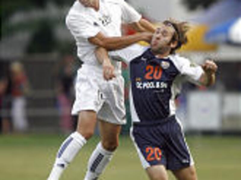 BYU's Morgan Gilliam (top) and Southern California's Josh Hansen collide while heading the ball Friday night in Provo during the PDL playoffs.