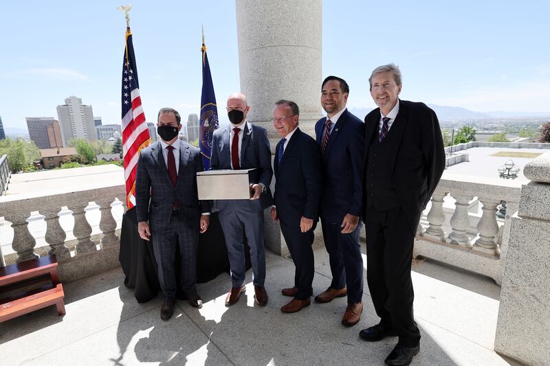 Gov. Spencer Cox poses with House Speaker Brad Wilson, R-Kaysville, Senate President Stuart Adams, R-Layton, Utah Attorney General Sean D. Reyes and Chief Justice Matthew B. Durrant at the Capitol in Salt Lake City prior to placing a new 100-year time capsule into a column on Wednesday, May 18, 2022.