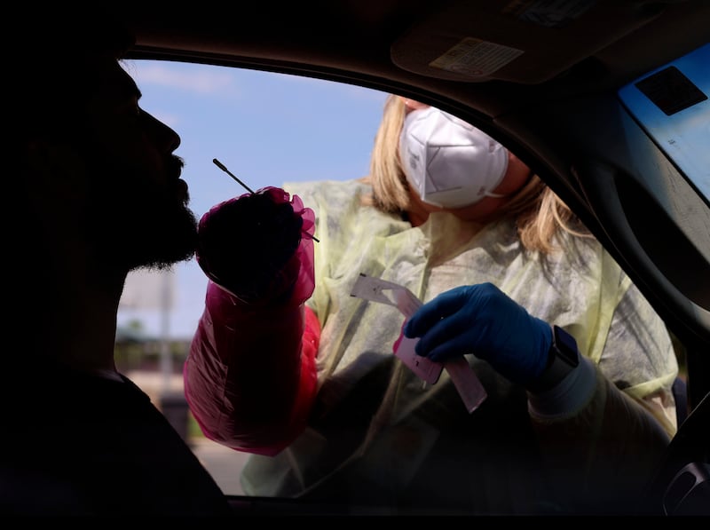 Registered nurse BreAnne Anderson administers a COVID-19 test in West Valley City, Utah.