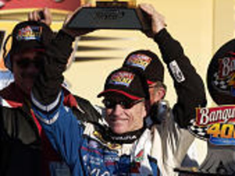 Mark Martin holds the trophy for winning NASCAR's Banquet 400 at Kansas Speedway on Sunday.