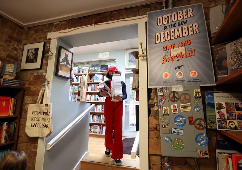 Alexis Powell carries a stack of books to the register at The King’s English Bookshop in Salt Lake City