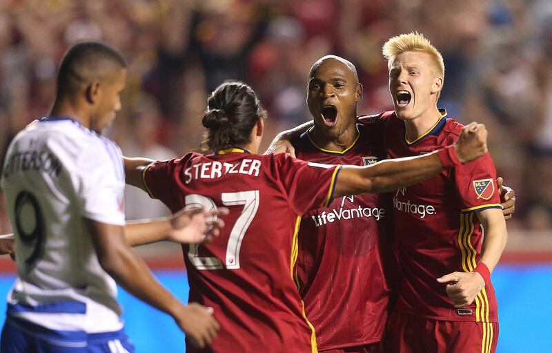 Real Salt Lake defender Jamison Olave (4) celebrates a late goal with teammates Real Salt Lake midfielder John Stertzer (27) and Real Salt Lake defender Justen Glad (15) as Real Salt Lake and FC Dallas play at Rio Tinto Stadium in Sandy on Saturday, Aug.