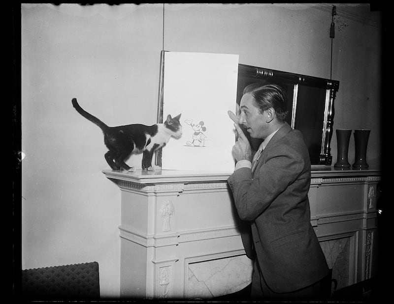 Walt Disney with a Mickey Mouse drawing from 1931.