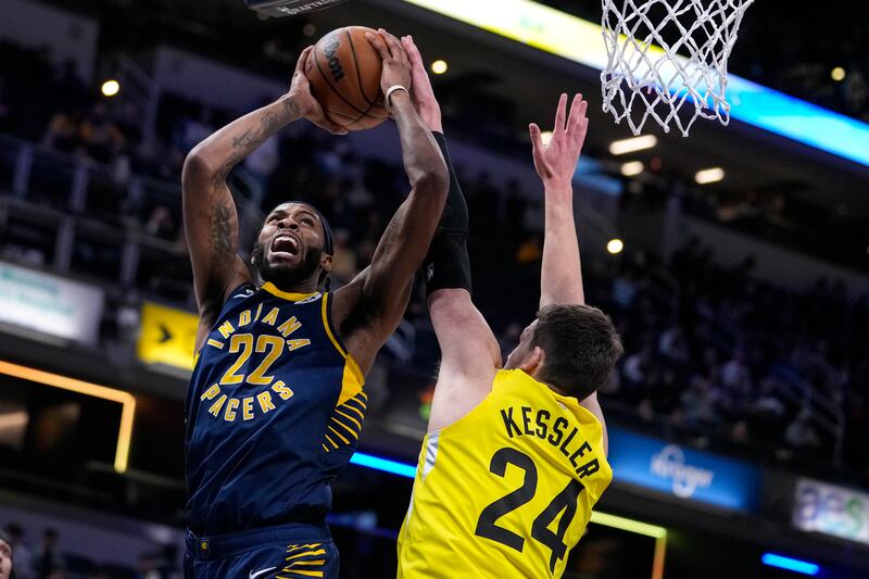 Indiana Pacers forward Isaiah Jackson (22) is fouled by Utah Jazz center Walker Kessler (24) during the first half of an NBA basketball game in Indianapolis, Monday, Feb. 13, 2023. (AP Photo/Michael Conroy)