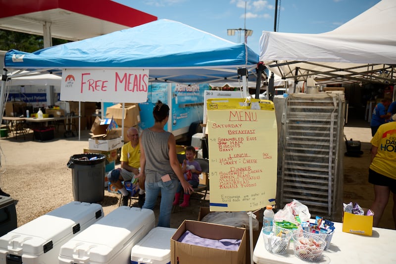 Volunteers receive free food as they assist with cleanup efforts in Hunt, Texas, on July 26, 2025, following the severe flooding in central Texas on July 4, 2025.