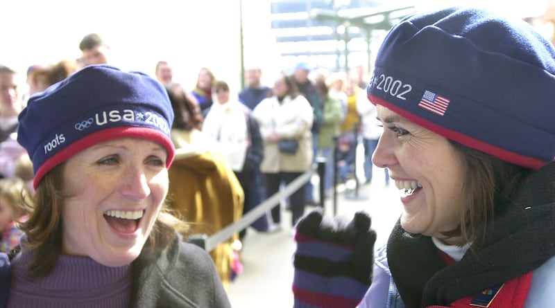 Joyce Morgan and Brenda Larsen wear the coveted Olympic team berets at the Gateway Center on Feb. 13, 2002.