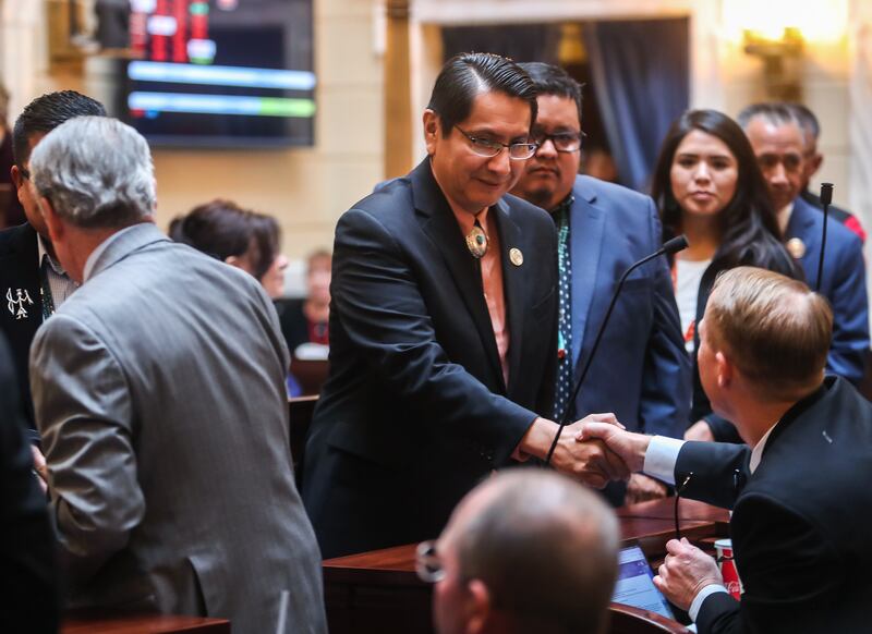 FILE - Navajo Nation President Jonathan Nez, shakes hands with state senators after Navajo Code Talkers from WWII were recognized at the Capitol in Salt Lake City on Monday, Feb. 4, 2019.