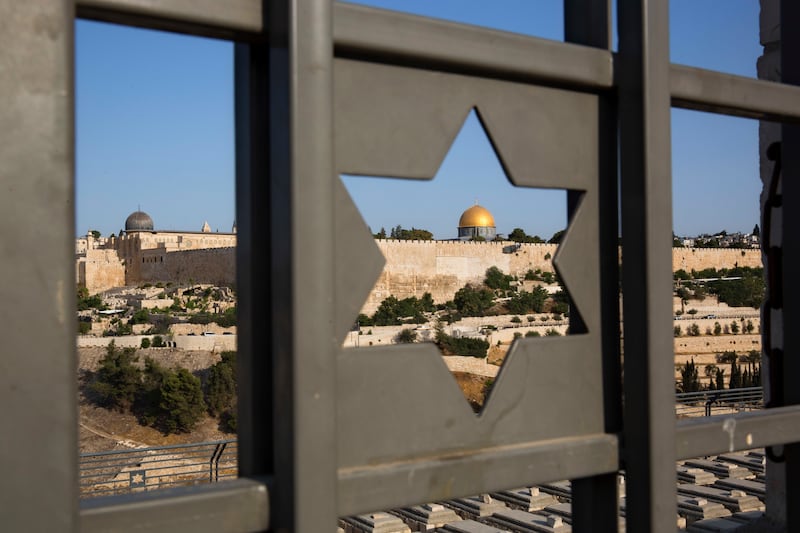 FILE - In this July 25, 2017 file photo, Jerusalem's Old City is seen trough a door with the shape of star of David. Turkey and the Palestinians have warned of dire diplomatic repercussions in the Middle East if President Donald Trump goes ahead with a po