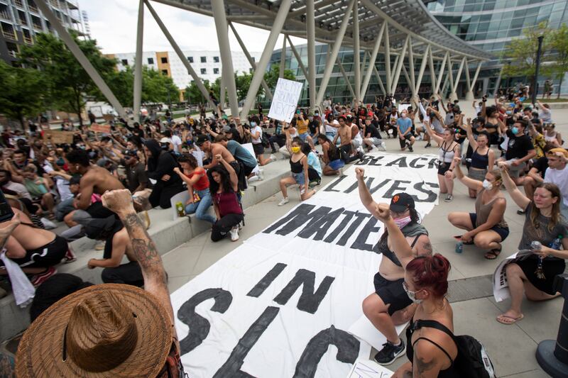 People kneel as they protest police brutality in Salt Lake City on Saturday, May 30, 2020. Daylong protests moved across the city Saturday after a peaceful demonstration to decry the death of George Floyd in police custody in Minneapolis turned violent.