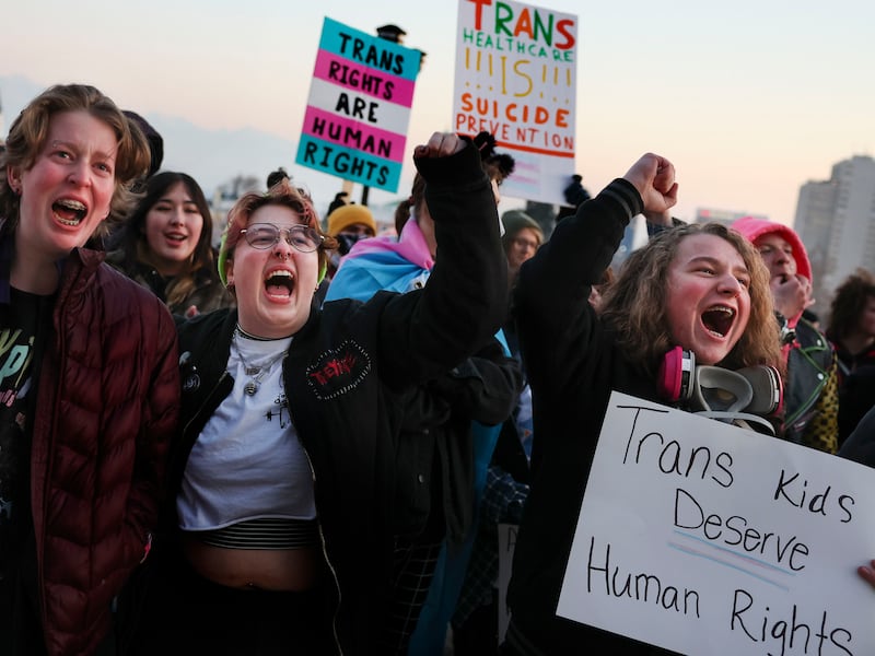 Elliot Ellis, Eamon Christiansen and Aiden Muhlestein rally in support of transgender youth at the Capitol.
