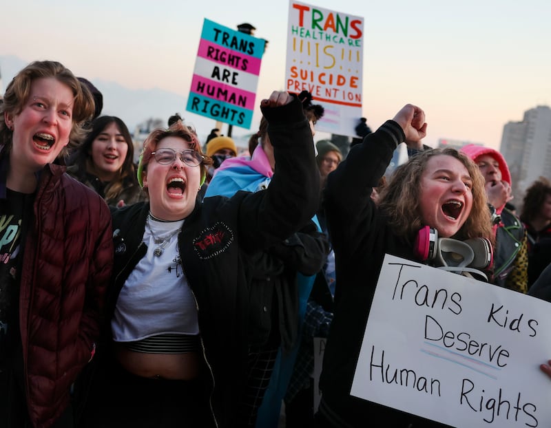 Elliot Ellis, Eamon Christiansen and Aiden Muhlestein rally in support of transgender youth at the Capitol.