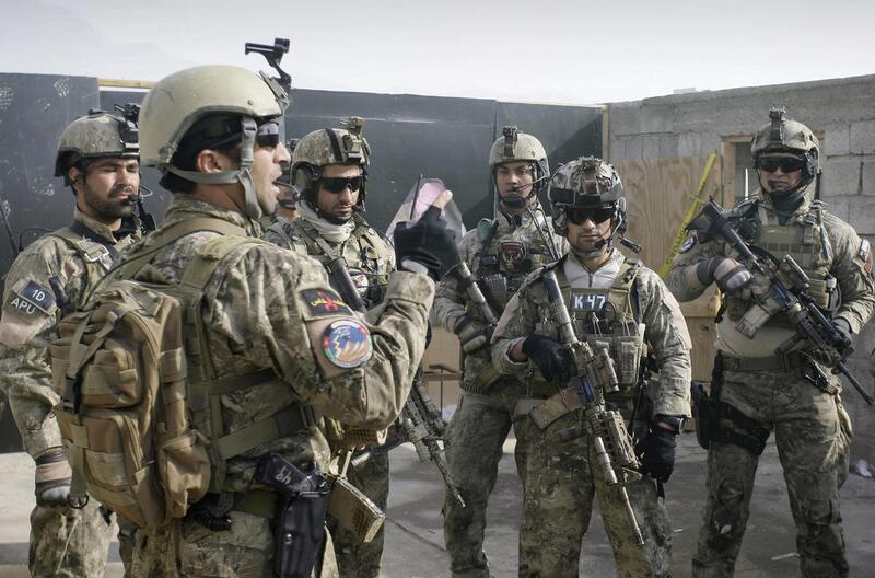 In this Monday, Jan. 14, 2013 file photo a member of the Afghan special forces, left, briefs soldiers after a training exercise on the outskirts of Kabul, Afghanistan. A senior U.S. commander said Saturday, March 30, 2013 that American special operations