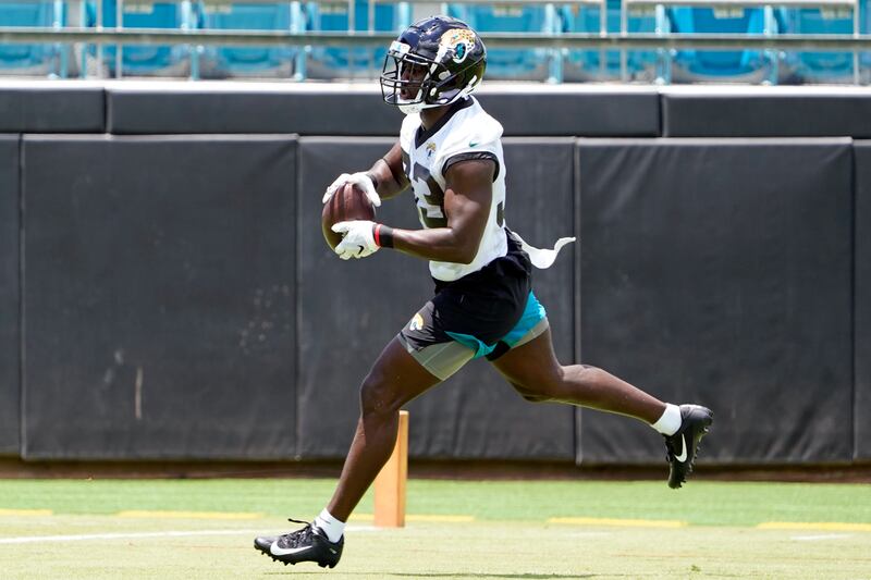 Jacksonville Jaguars inside linebacker Devin Lloyd (33) catches a pass during a drill.