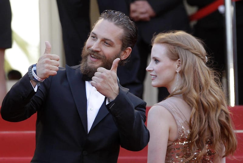 Actors Tom Hardy, left and Jessica Chastain arrive for the screening of Lawless at the 65th international film festival, in Cannes, southern France, Saturday, May 19, 2012. Hardy will be reading bedtime stories with his dog to help soothe viewers during the COVID-19 pandemic.
