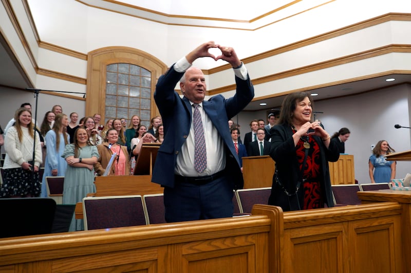 Elder Ronald A. Rasband and his wife, Sister Melanie Rasband, make heart gestures after a devotional.