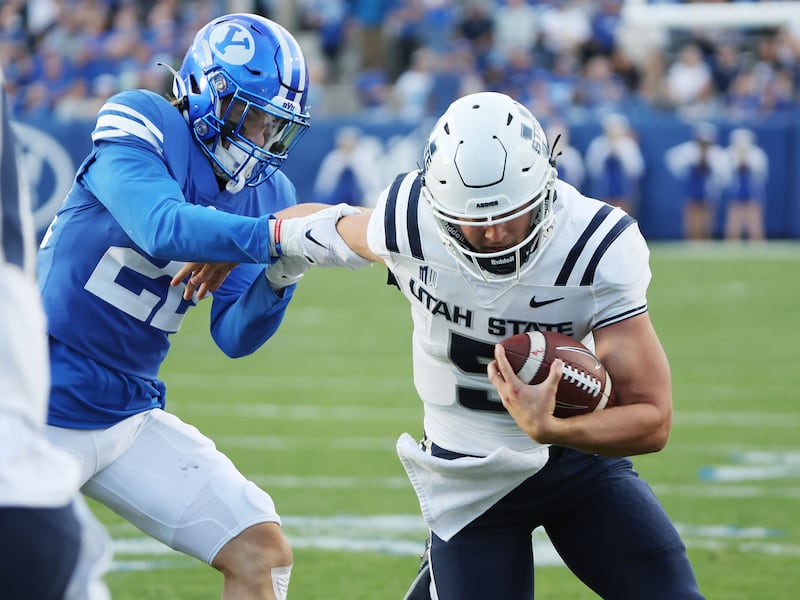 Utah State Aggies quarterback Cooper Legas (5) runs for a touchdown against BYU in Provo.