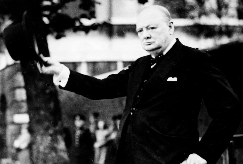 Prime Minister Winston Churchill doffs his hat as he takes the salute as the Civil Service Home Guard marches by him on review on the Horse Guards Parade, Sept. 17, 1942.