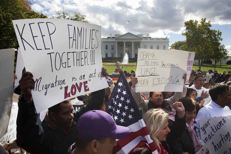 People rally for comprehensive immigration reform, Friday, Nov. 7, 2014, outside the White House in Washington.