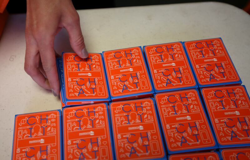 Jess Bigler, prevention specialist with Davis Behavioral Health, hands out conversation cards for parents and children after a showing of the documentary film "Angst" at Clearfield High School in Clearfield on Monday, April 30, 2018.