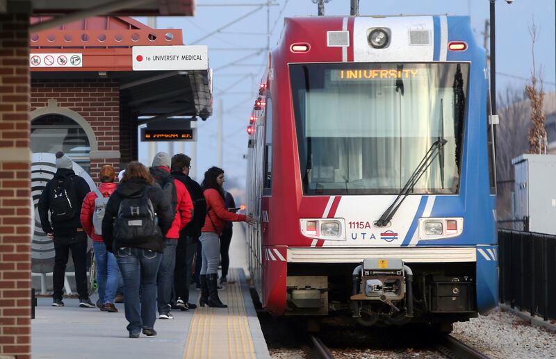 FILE - People board a red line train at the Bingham Junction Trax Station in Midvale on Friday, Jan. 5, 2018.