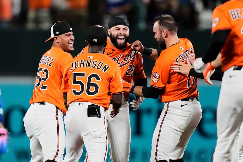 Baltimore Orioles' Emmanuel Rivera, third from left, celebrates with teammates after hitting a walk-off single during the ninth inning of a baseball game against the Los Angeles Dodgers, Saturday, Sept. 6, 2025, in Baltimore. (AP Photo/Stephanie Scarbrough)
