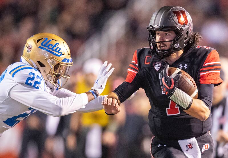 Utah quarterback Cam Rising runs down the sideline during game against UCLA at Rice-Eccles Stadium in Salt Lake City.