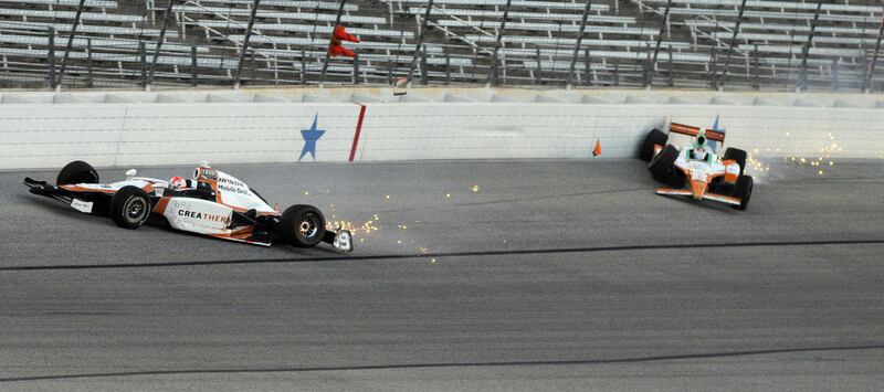 IndyCar drivers Wade Cunningham, left, and Charlie Kimball hit the wall during the first race of the Texas Firestone Twin 275 auto races at Texas Motor Speedway in Fort Worth, Texas, Saturday, June 11, 2011.