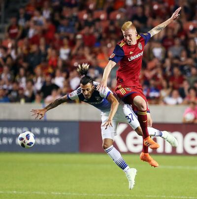FC Dallas forward Maximiliano Urruti (37) and Real Salt Lake defender Justen Glad (15) go up for a header during MLS soccer in Sandy on Saturday, July 7, 2018.