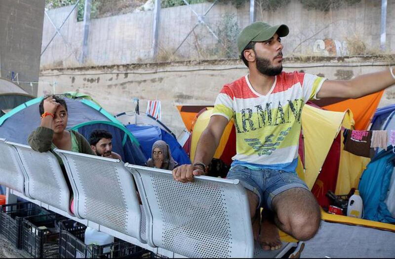 FILE - Syrian refugees camp under an overpass near the Port of Piraeus in Athens, Greece, in July 2016.