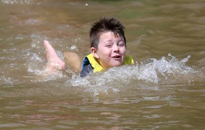 Abram Henriquez swims in a life jacket from the life jacket loaner station at Jordanelle State Park on Wednesday, June 26, 2019.