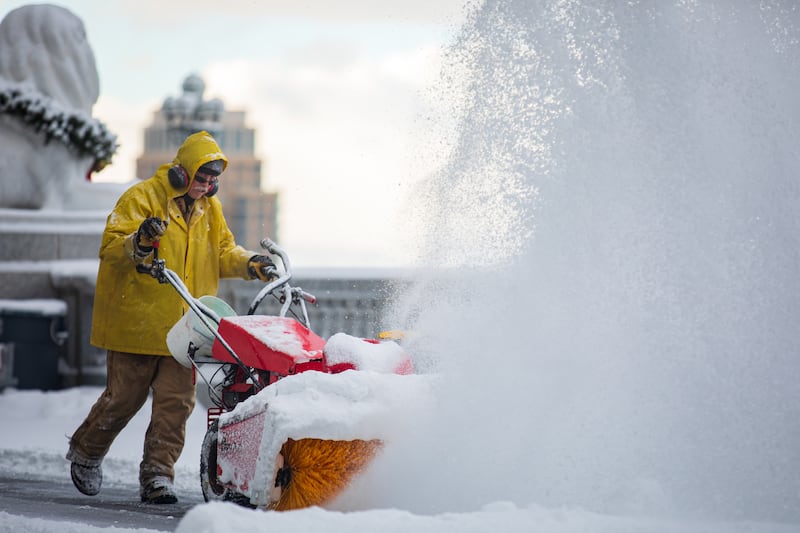 Workers clear snow at the Utah Capitol on Friday, Dec. 10, 2021.
