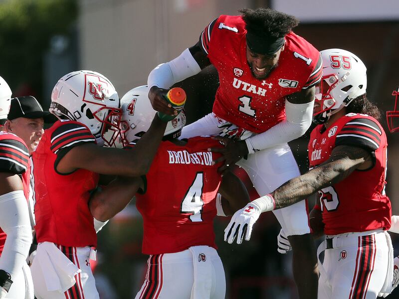 The Utes celebrate after defensive back JaTravis Broughton (4) intercepts an Idaho State pass during game in Salt Lake City.